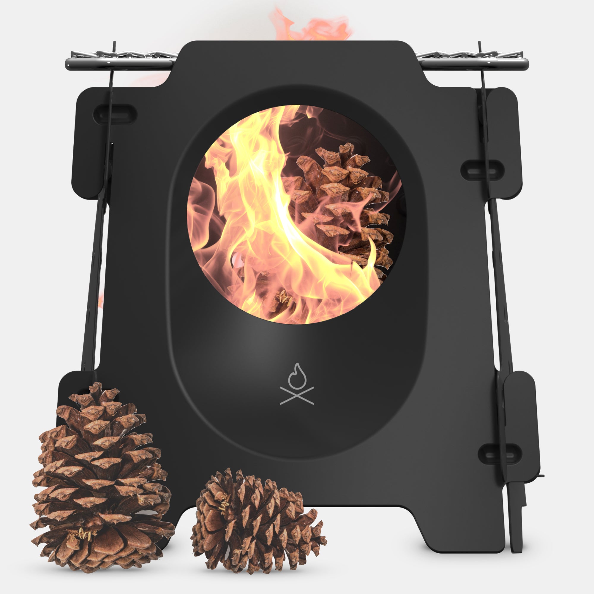 The Stöker Stove by Überleben is a sleek, black, twig stove with a circular opening displaying a bright, roaring fire inside.  Crafted from stainless steel, this stove showcases a simple, minimalist design on a plain white background.