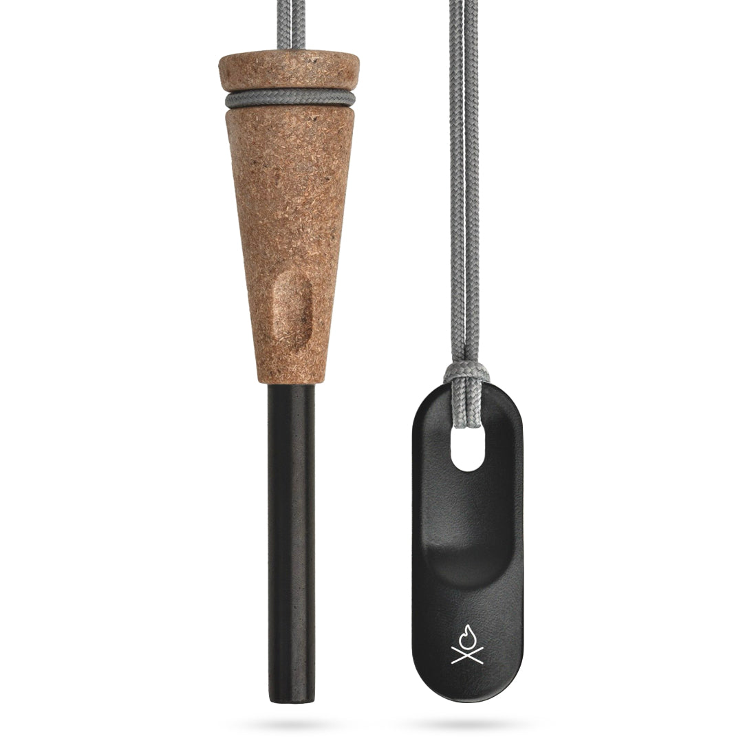 The Zünden 2.0 Fire Starter, by Überleben, is shown, featuring a wood composite handle with a ferro rod and a black metal striker attached to a gray cord. 